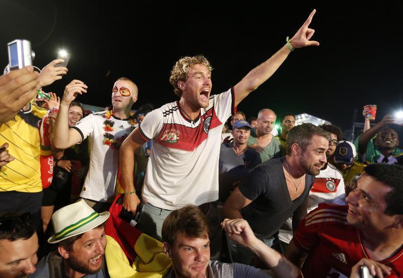 German soccer fans celebrate after watching a broadcast of the 2014 World Cup semi-final between Brazil and Germany at Copacabana beach in Rio de Janeiro, July 8, 2014. 