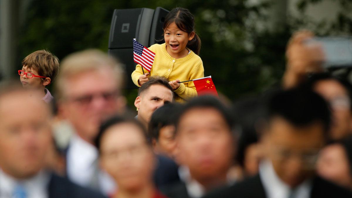 A girl holds a US and a Chinese flag during the arrival ceremony for China's President Xi Jinping and first lady Madame Peng Liyuan at the White House in September, 2015.