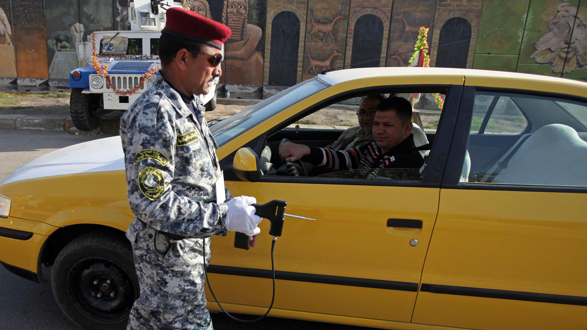 An Iraqi police officer uses the device to inspect a car at checkpoint in central Baghdad, Iraq, 2010. 