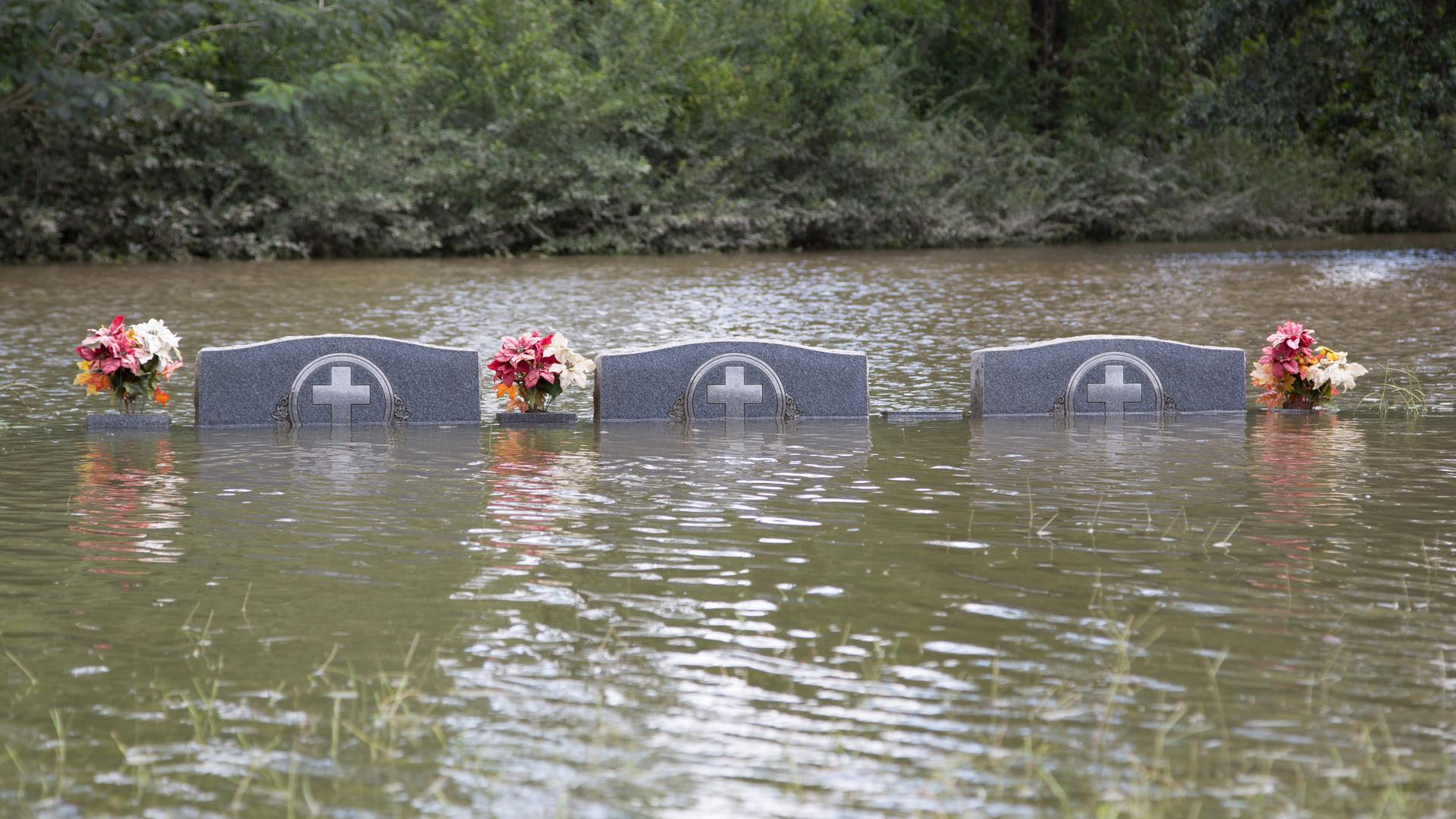 Floodwaters recede from a cemetary in Greenwell Springs, Louisiana on August 14th. More than two feet of rain fell on parts of the state in just a few days, flooding out roughly 40,000 homes and killing more than a dozen people.