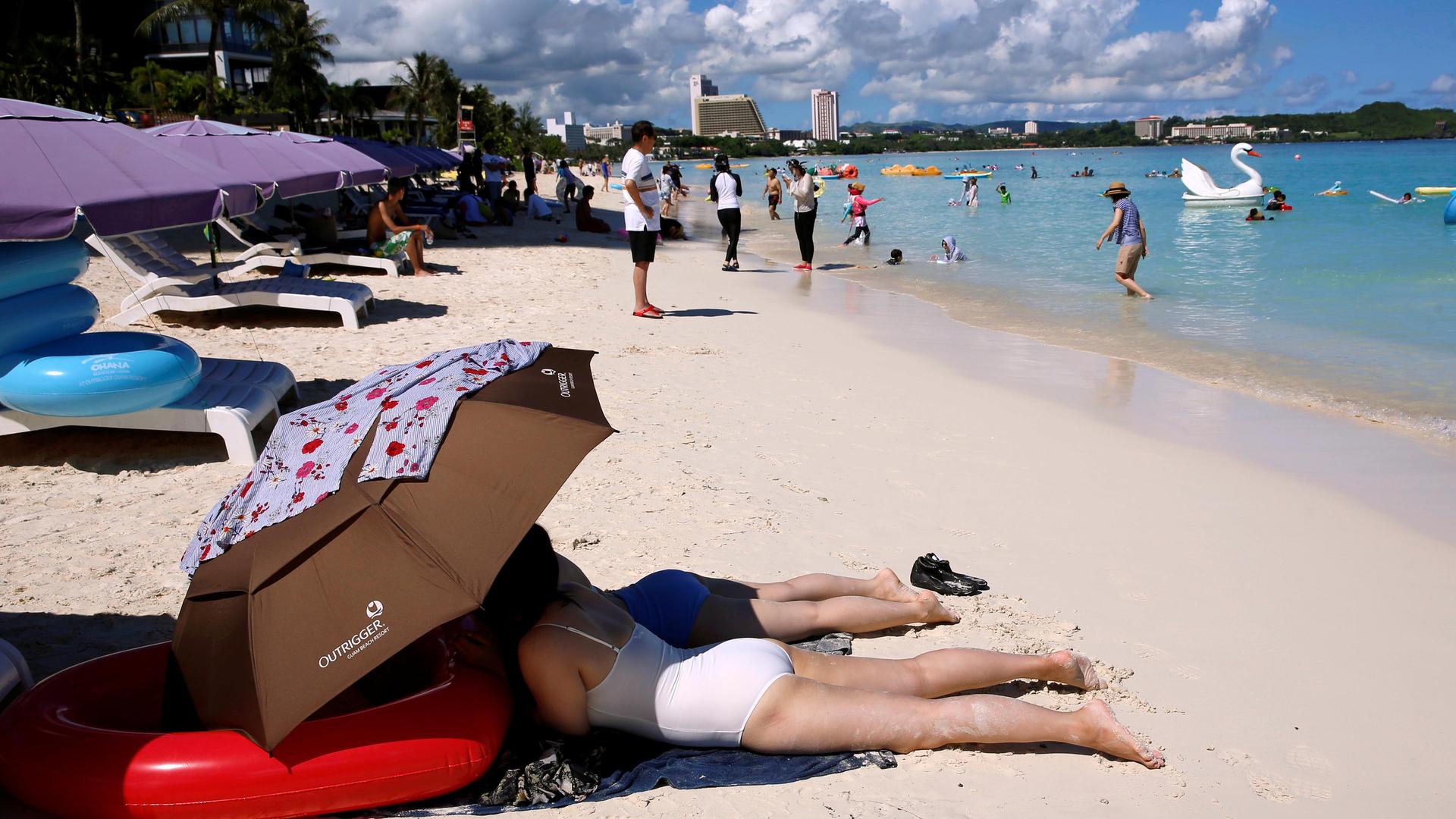 Tourists enjoy the beach in Tumon, Guam