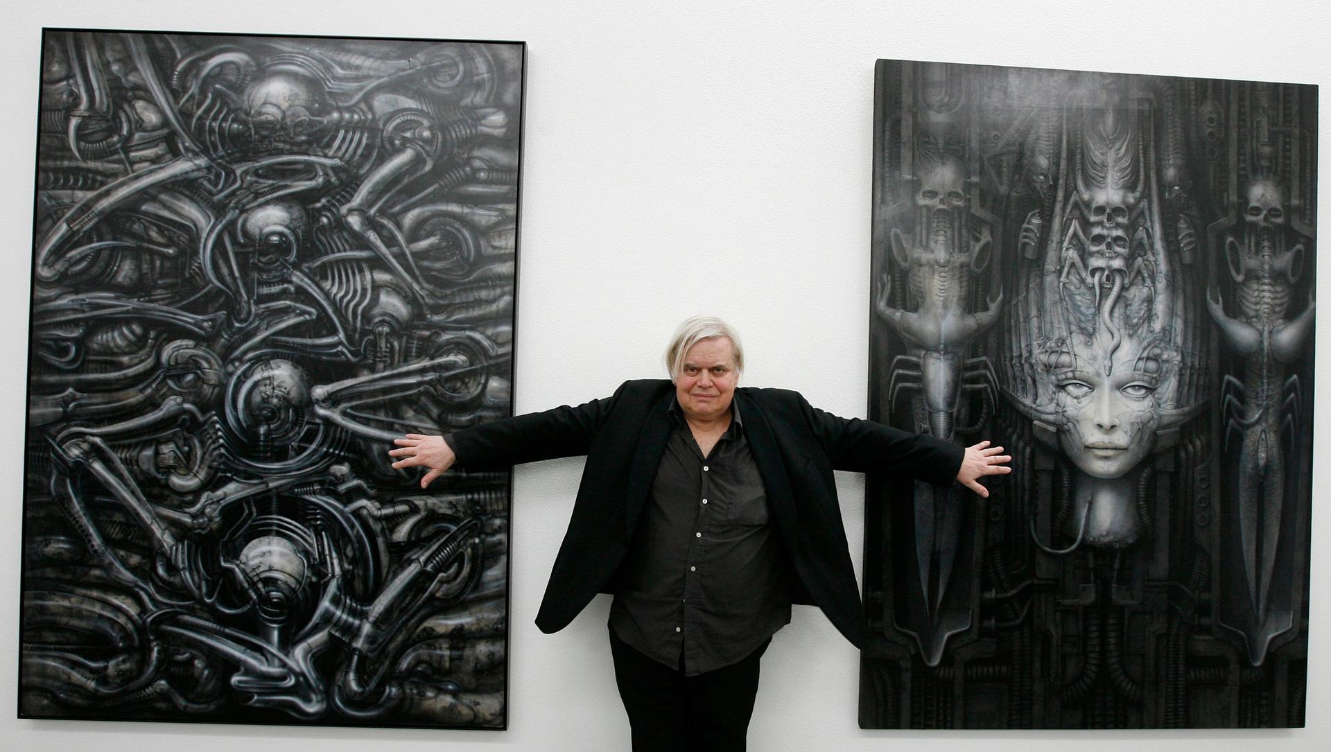 HR Giger poses with two of his works at his museum in Chur, Switzerland. Photograph: Arno Balzarini/AP