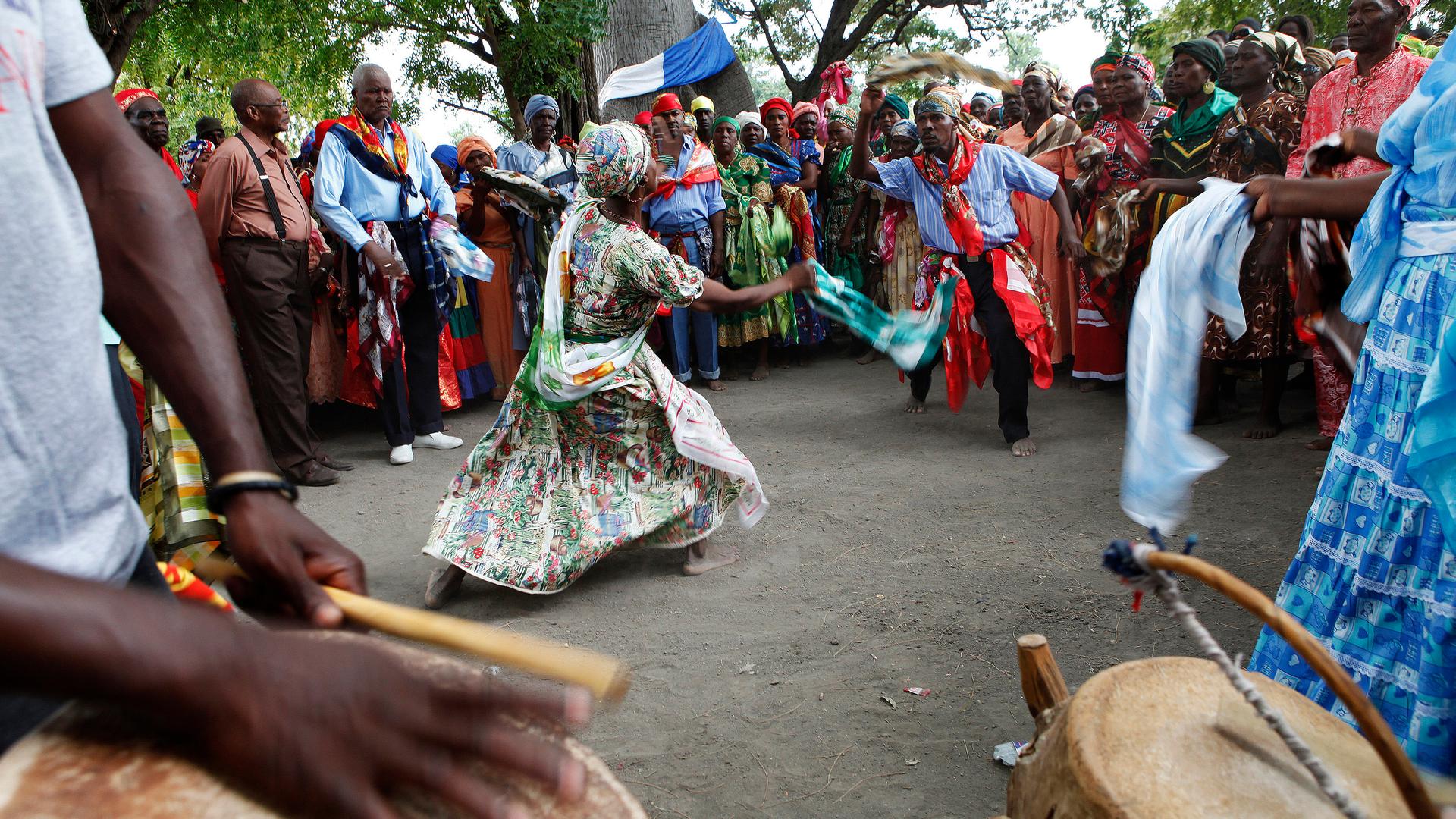 Haitians dance under a sacred ceibo tree in a voodoo ritual on the third day of the annual gathering in the Souvenance community. Descendants of the people of Dahomey, a former kingdom in what is now present-day Benin, show their devotion to their ancesto
