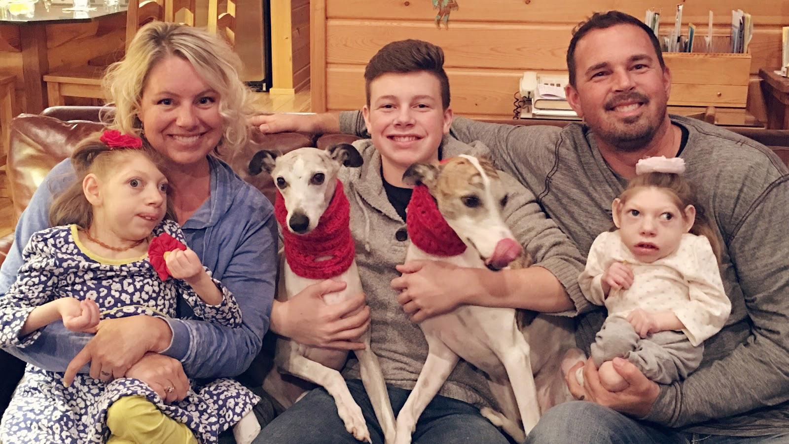 The Hartley family. (Left to right) Gwen holding Claire (age 14); Cal (age 17); Scott holding Lola (age 9); and their two whippets, Romeo and Cash.