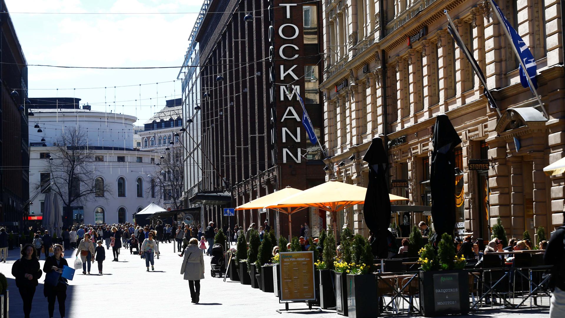 People walk past Stockmann shopping center in Helsinki, Finland, on May 6, 2017.