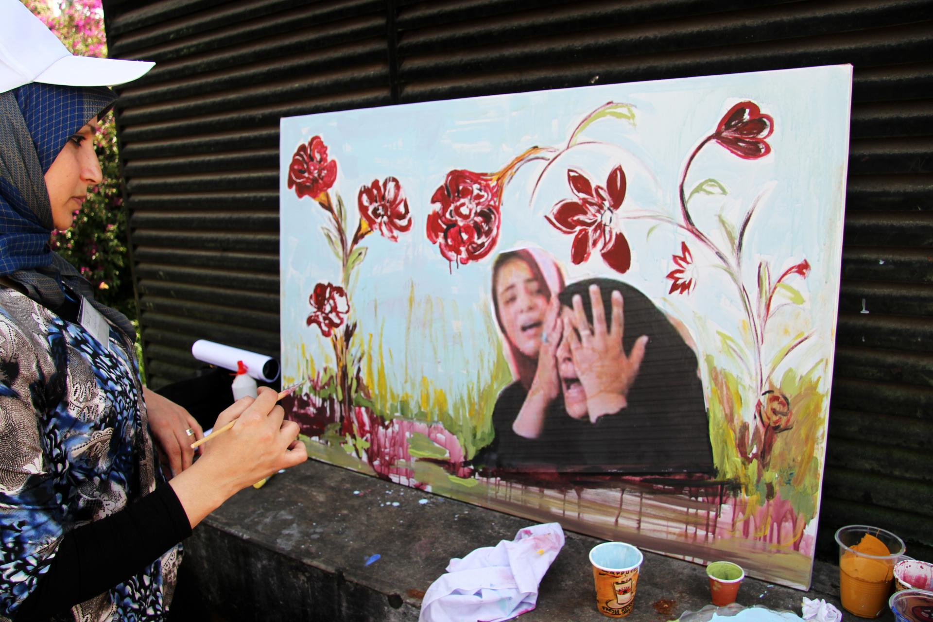 A Beirut artist participates in an event staged by a municipality controlled by Hezbollah to honor those killed in a wave of car bombings in Lebanon. 