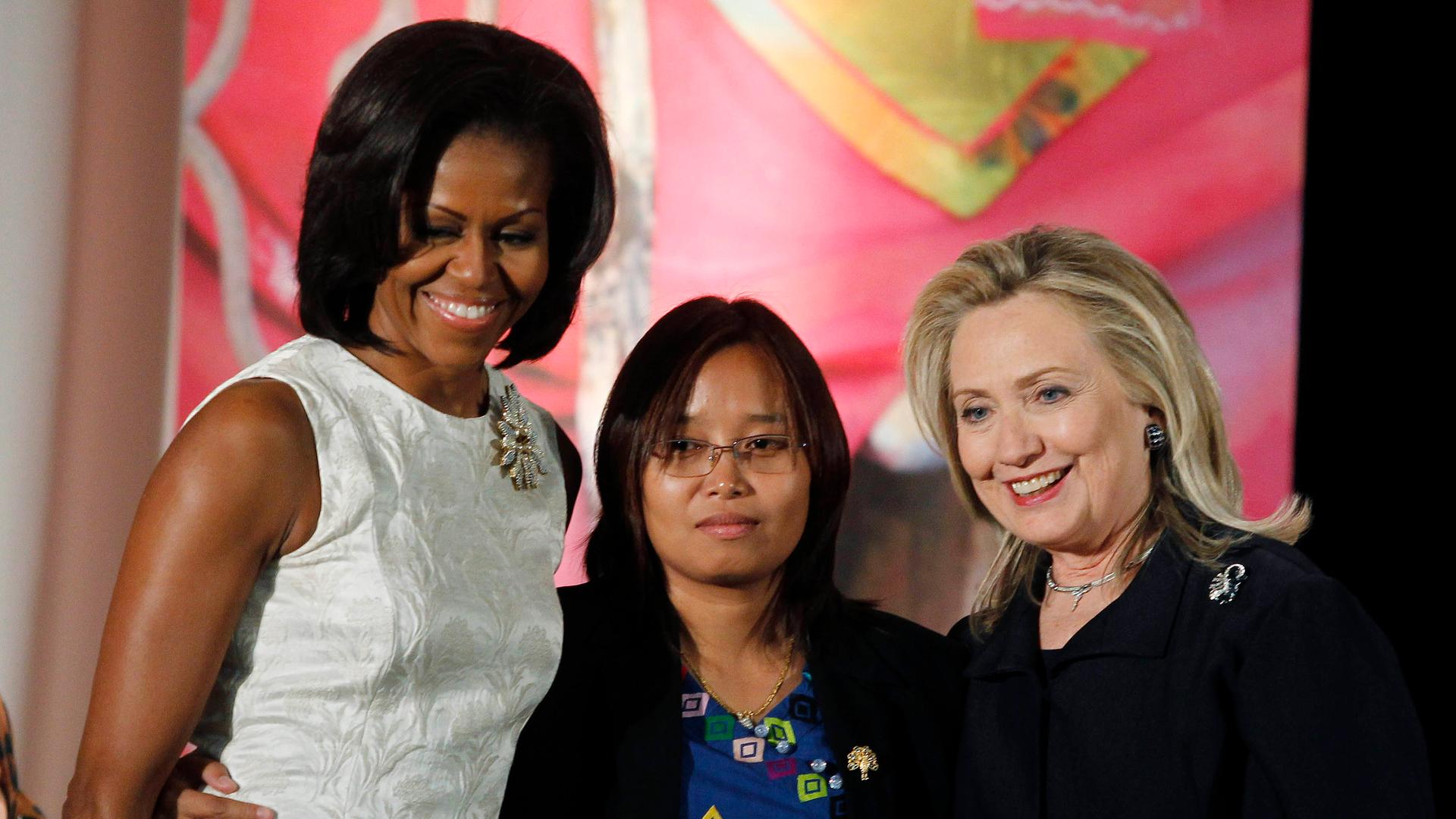 Zin Mar Aung of Myanmar (center) receives congratulations from First Lady Michelle Obama and U.S. Secretary of State Hillary Clinton as she receives a State Department 2012 International Women of Courage Award.