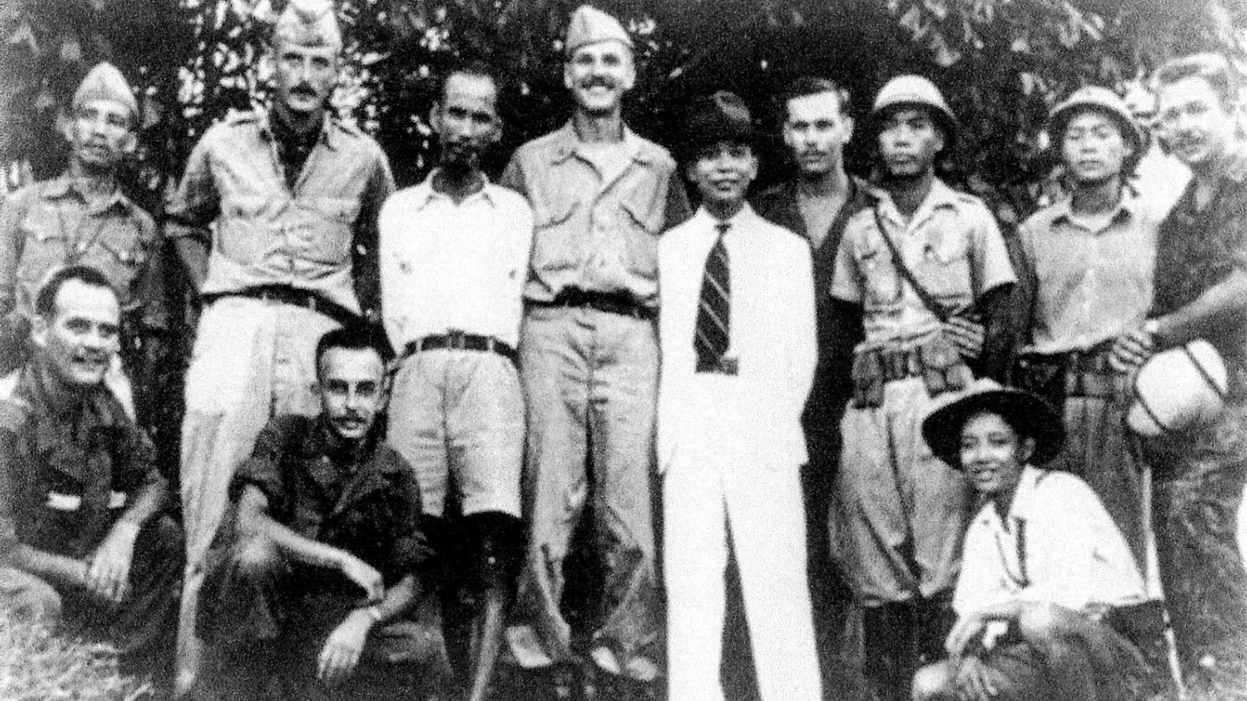 Ho Chi Minh (standing, third from left), and Vo Nguyen Giap (in white suit), with an OSS team in 1945
