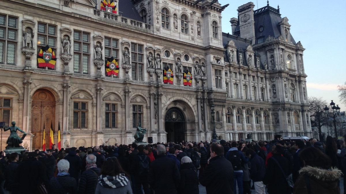 Parisians observe a moment of silence in front of City Hall in honor of the Belgian victims and their own. 