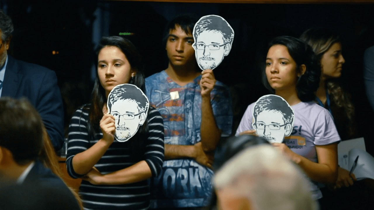 Brazilian activists hold Snowden masks 