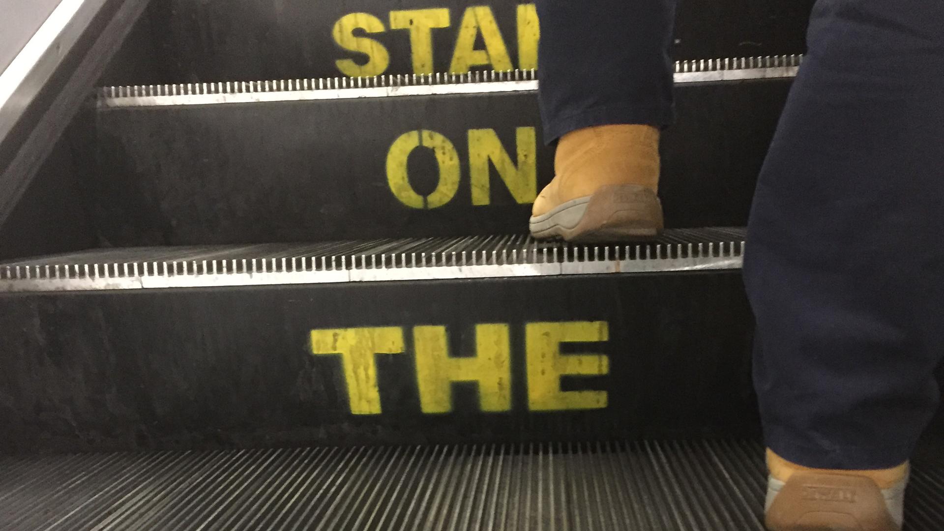 The words, "Stand on the right," painted into an escalator in London.