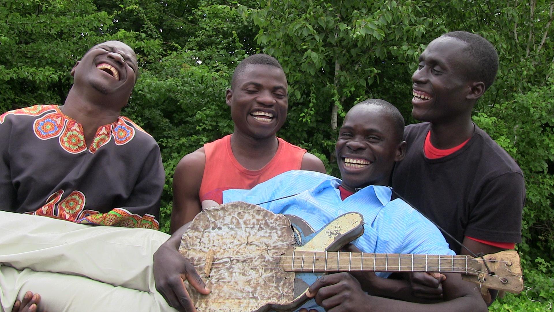 The Malawi Mouse Boys pose with one of their homemade instruments. From left to right: Josephy Nekwankwa, Zondiwe Kachingwe, Nelson Muligo, Alfred Gavanala