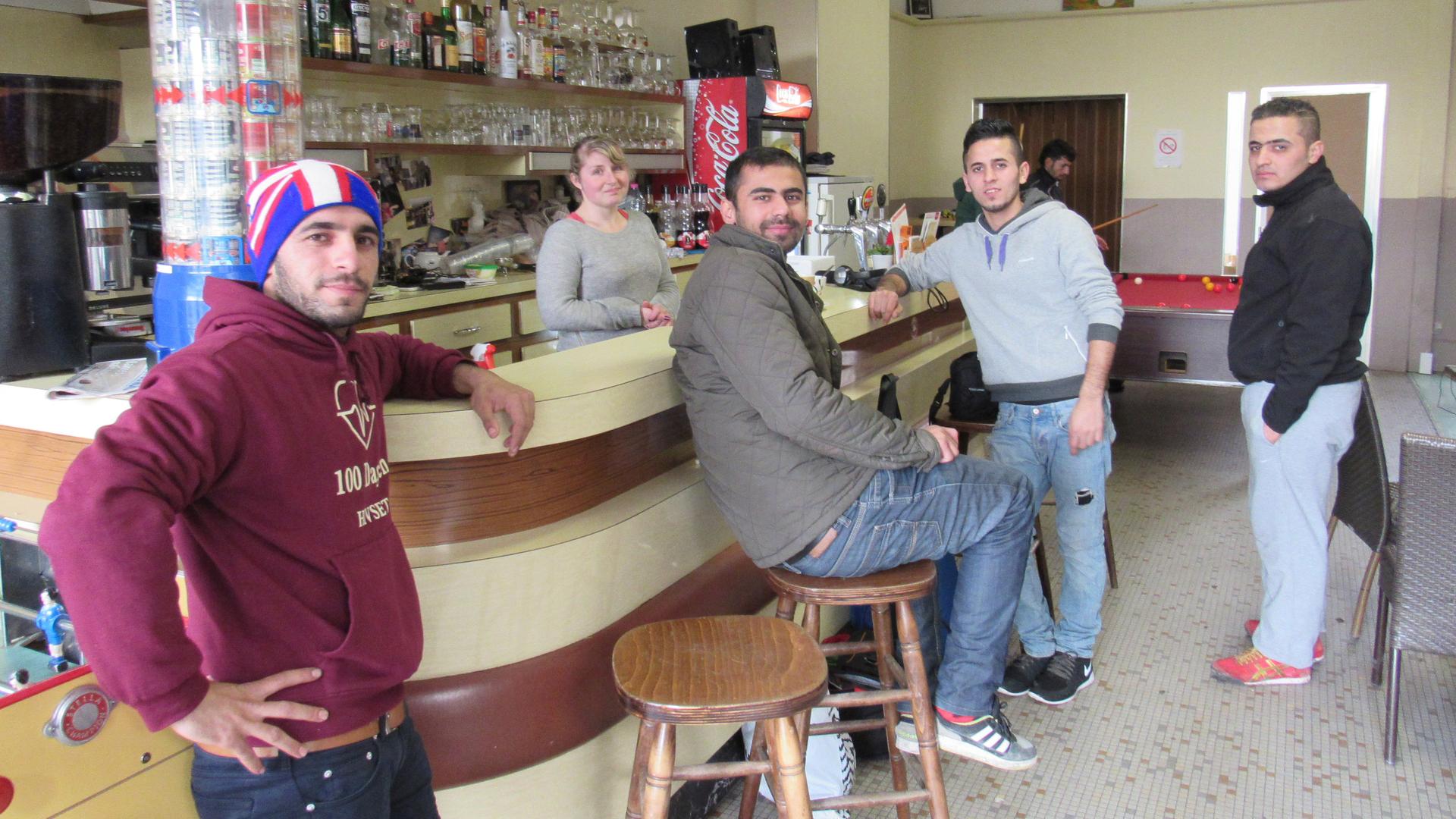 Bartender and Café Elleboode owner Laura Six welcomes Kurdish migrants from a nearby refugee camp.