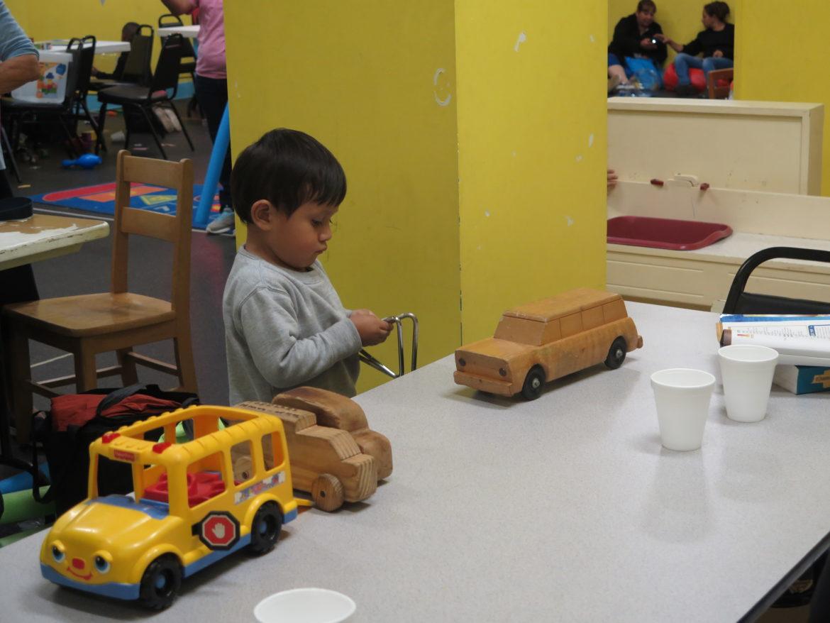 A young child takes refuge from Hurricane Harvey and plays with toys at a downtown church playroom.
