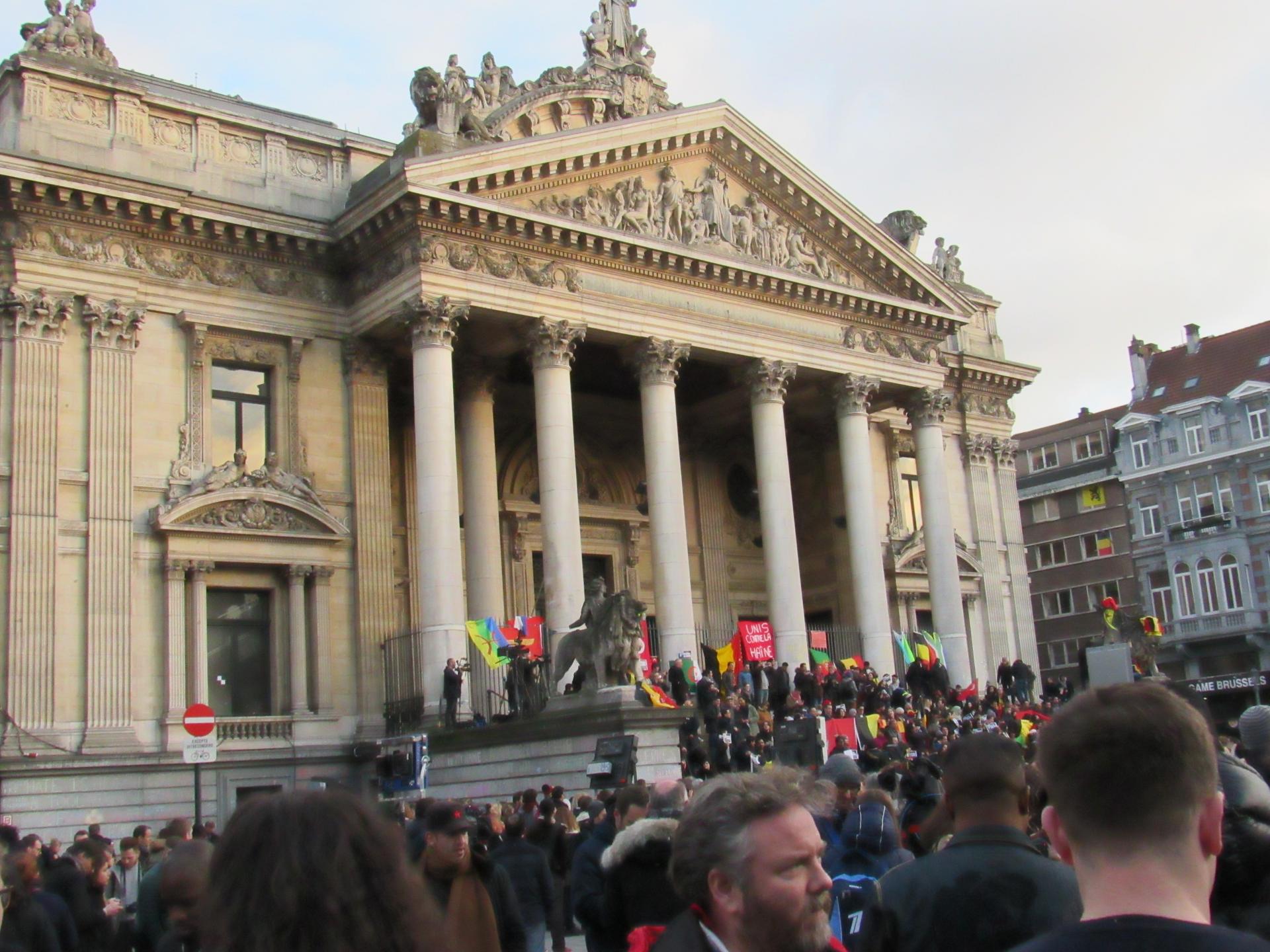 Crowds gather on the steps of the old Brussels stock exchange, Place de la Bourse.