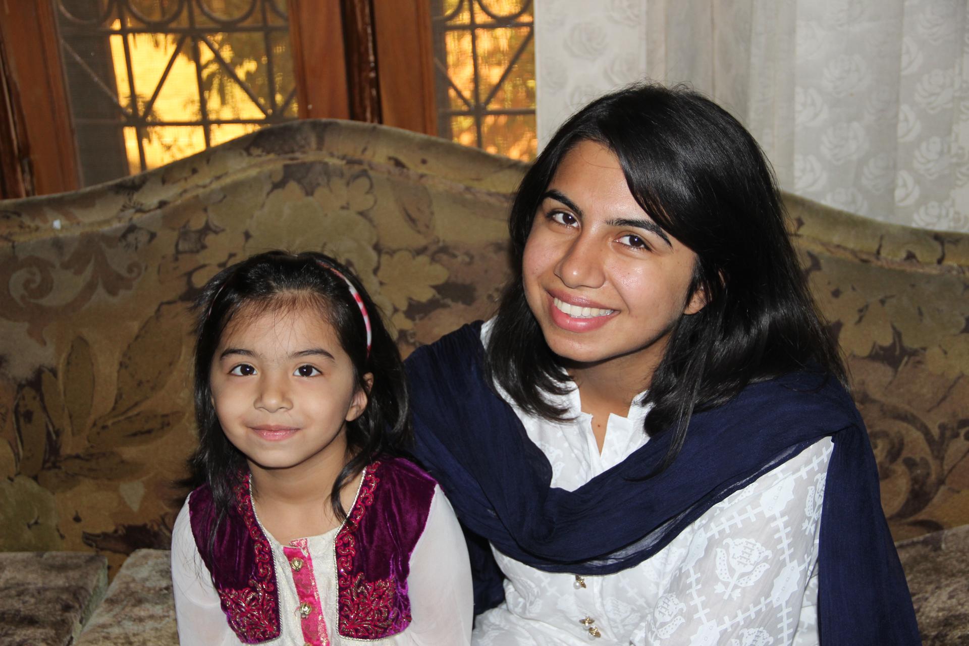 Umaima Awan sits with her mother, Um-E Salma, at the family’s house in Jauharabad, Pakistan.