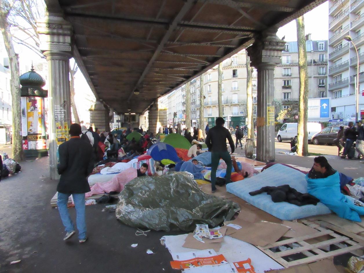 Asylum-seekers make temporary homes under the bridge of Paris' Stalingrad metro station.