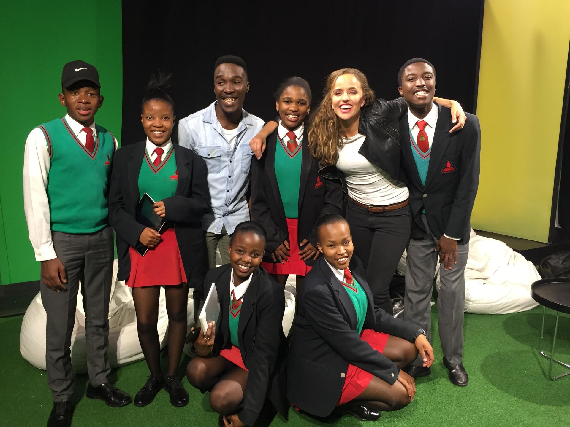 MTV Host Tinashe Venge, center, and Across Women's Lives reporter Jasmine Garsd, second from right, stand with South African students