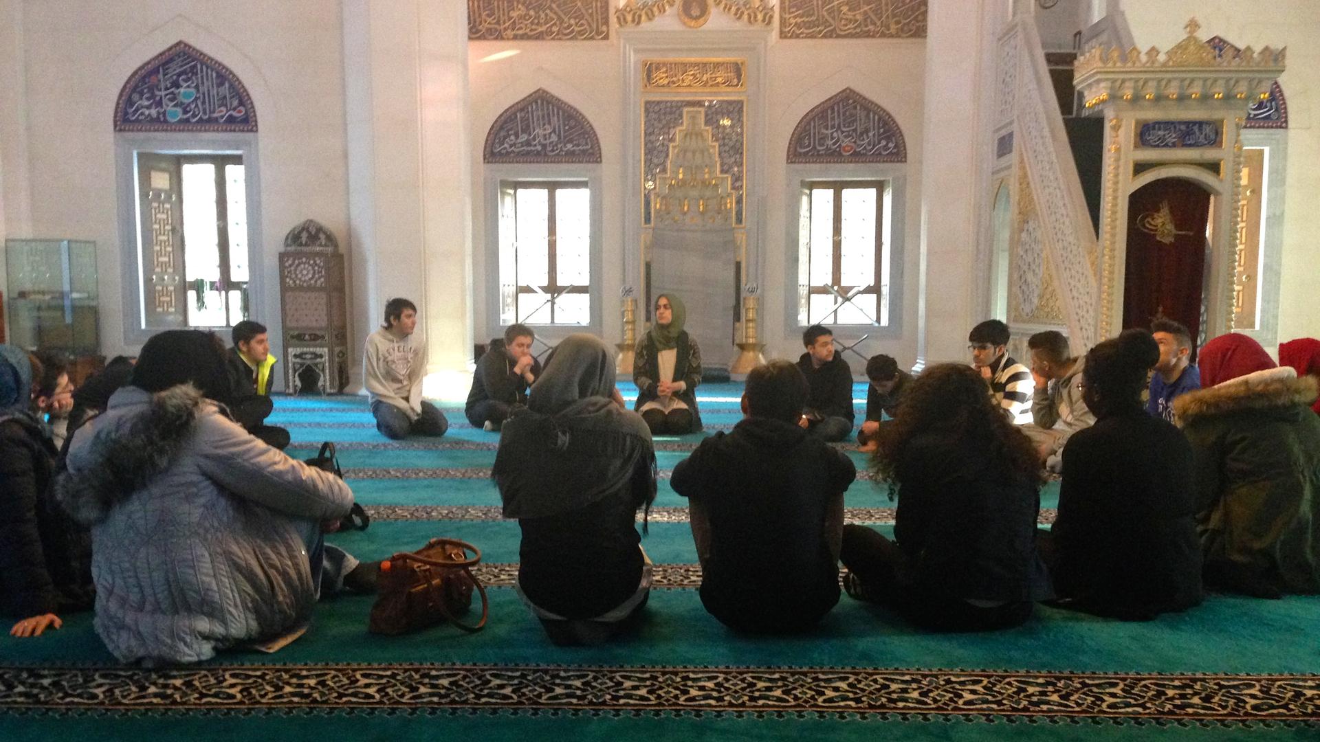 Betul Ulusoy (center back) leads an educational tour of Sehitlik Mosque in Berlin. 