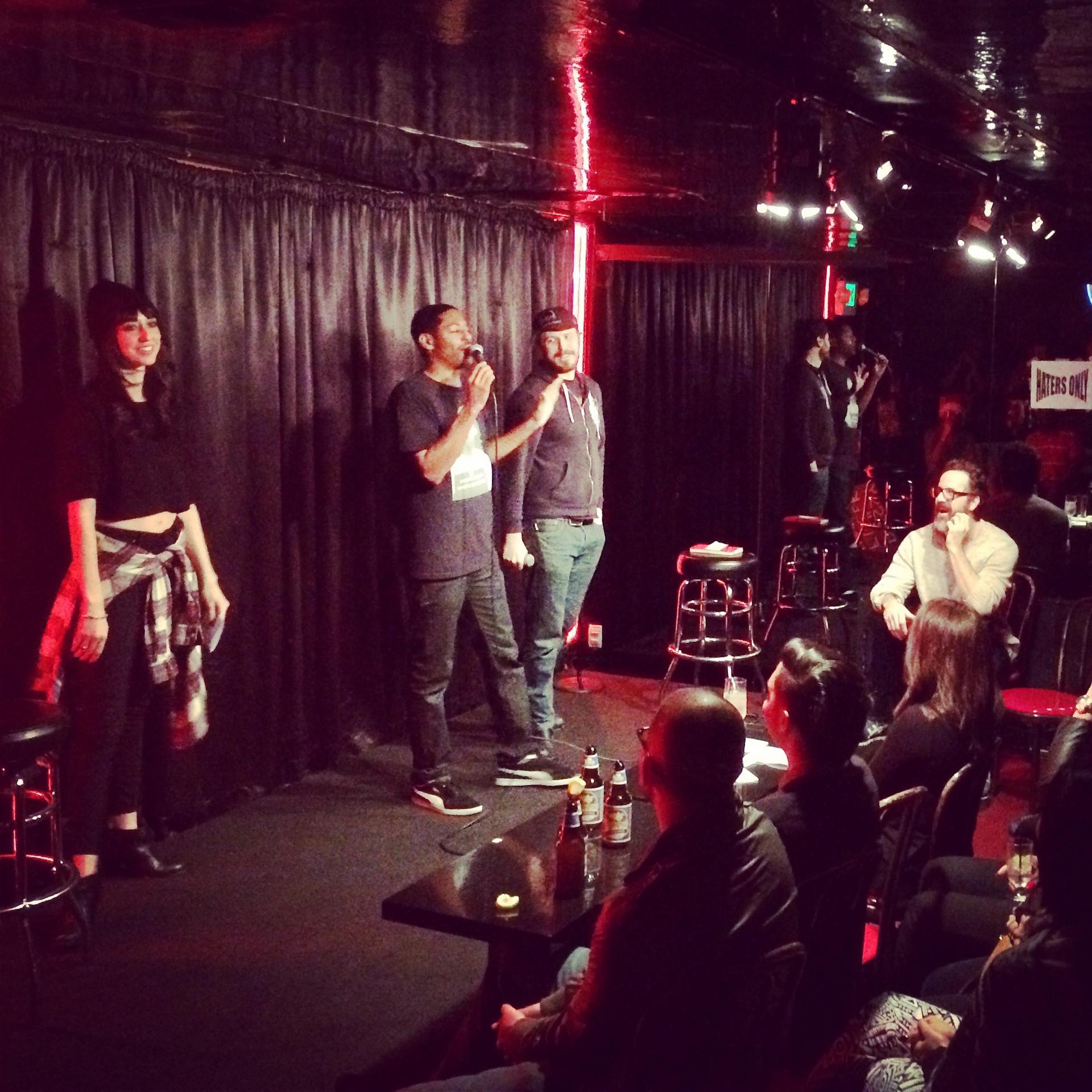 Host Brian Moses stands between two warring comics at the Comedy Store's Roast Battle.