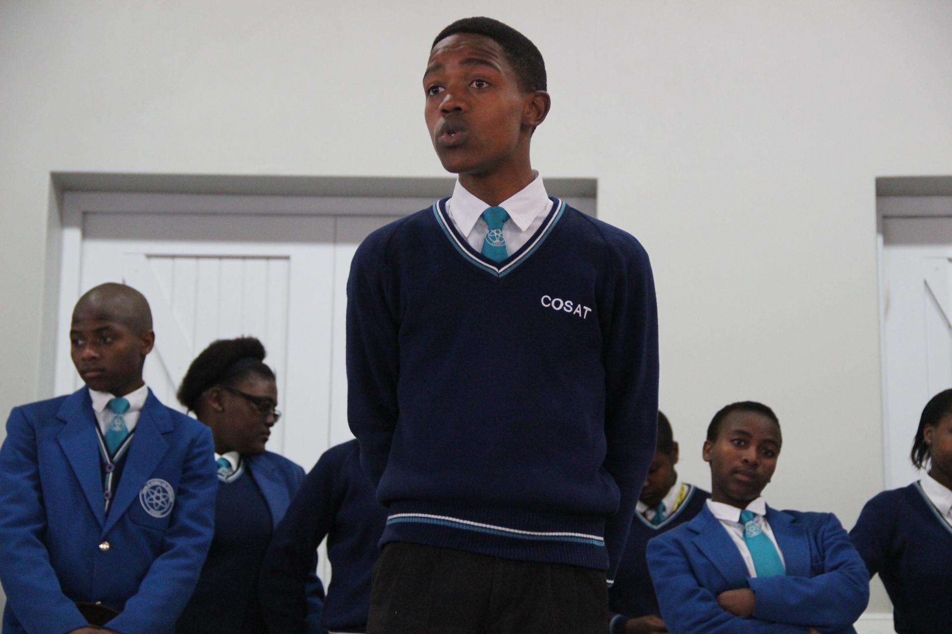 Siyathemba, a junior at COSAT, delivers a speech during student council elections.