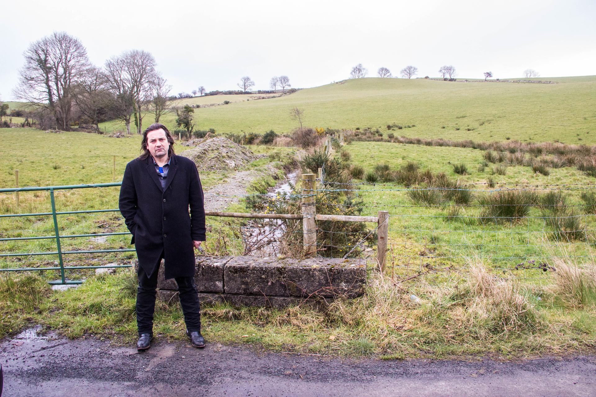 Éamonn Ó Ciardha teaches Irish language and history at Ulster University in Derry. The stream behind him marks the border between Northern Ireland and the Republic of Ireland. It's on a tiny country road just outside of Derry. Ó Ciardha says that trying t