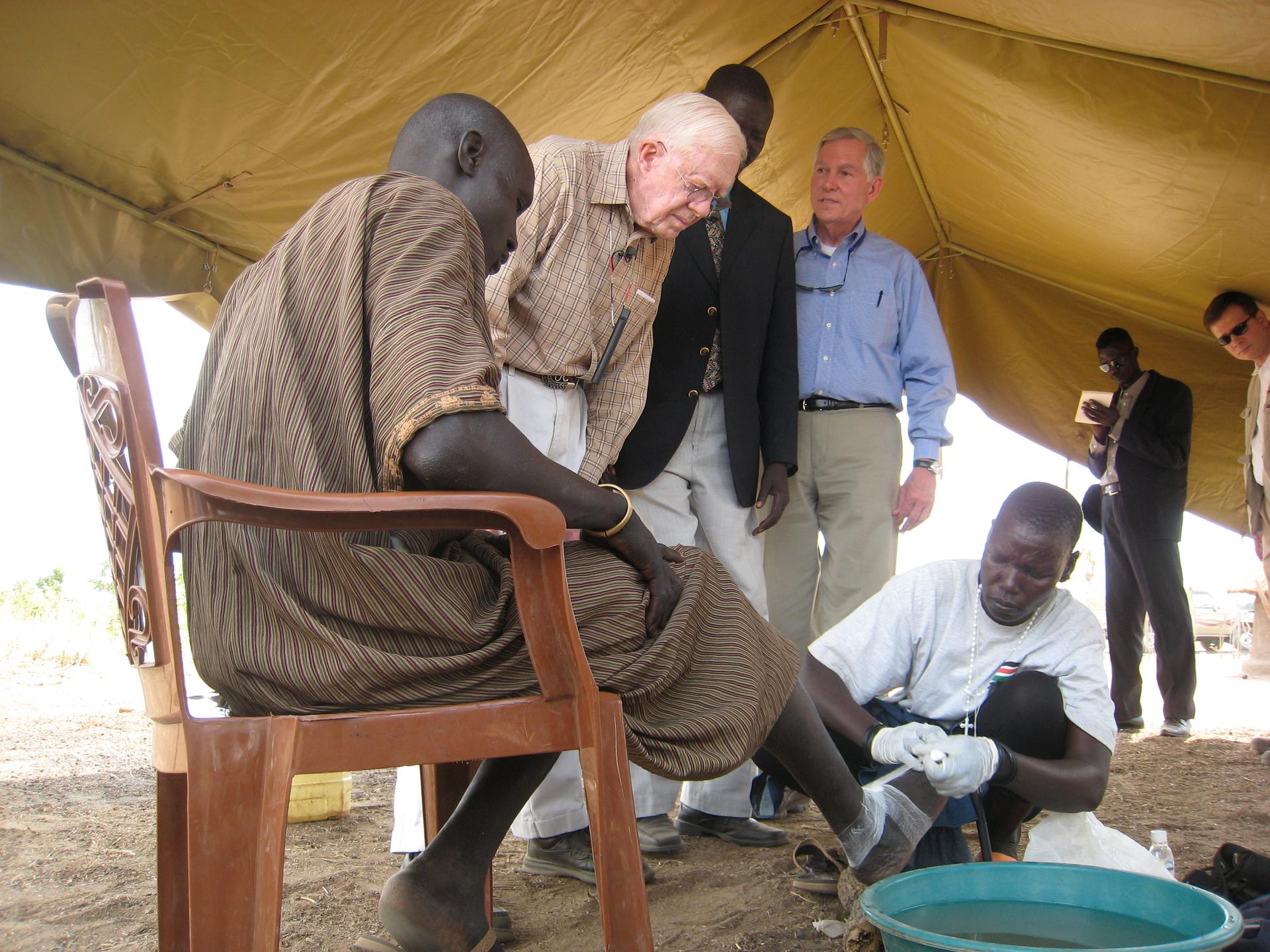 Former US President Jimmy Carter looks on as herder Garbino Kenyi is treated for Guinea worm in South Sudan.