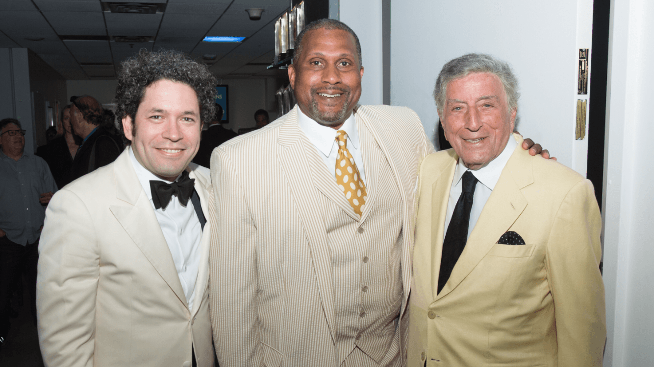 Tavis Smiley, center stands backstage with Gustavo Dudamel and Tony Bennett.