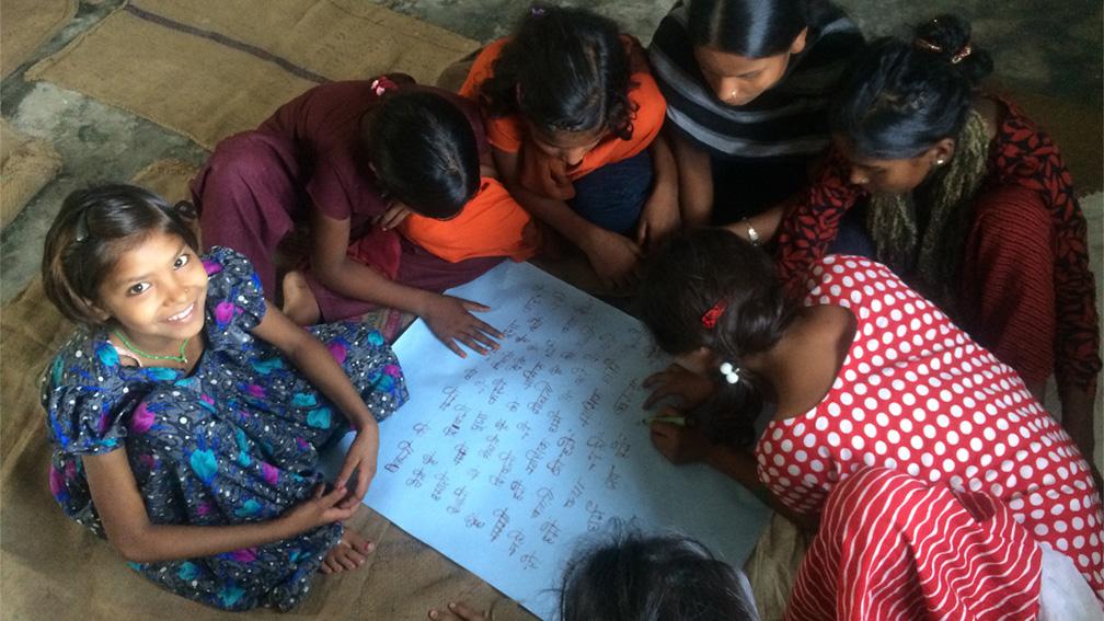 A group of young girls makes a list of questions on menstruation after watching a film about the issue.
