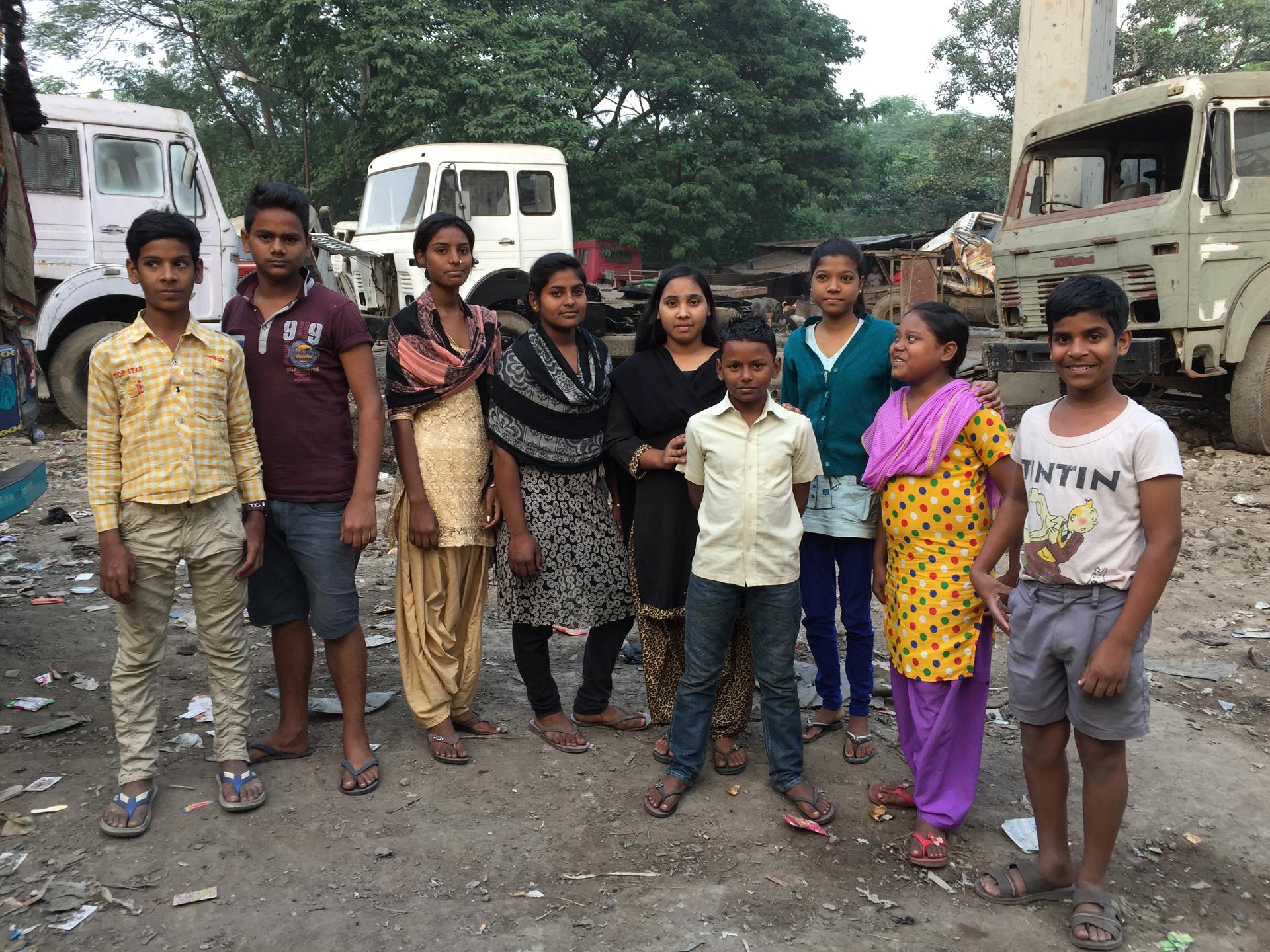 A group of children from the Shaktimaan group pose together in a slum in Kolkata, India, convincing child dropouts to go back to school. 