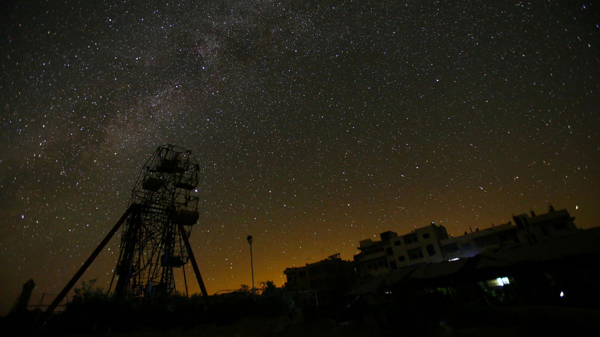 A ferris wheel stands in the rebel-controlled area of Maaret al-Numan town in Idlib province, Syria. Stars fill the night sky over the Syrian rebel-held city of Idlib, and the streets are eerily quiet.