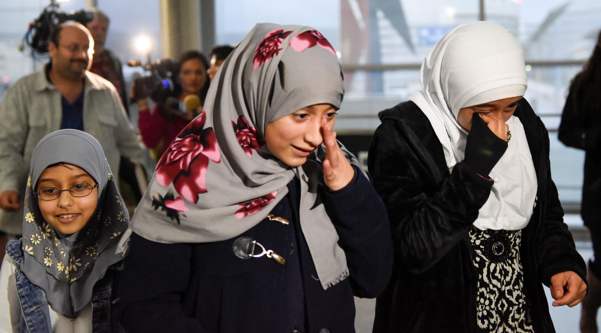 Twelve-year-old Eman Ali of Yemen was reunited with her sister Salma, right, at San Francisco International Airport in San Francisco, California, on Feb. 5.