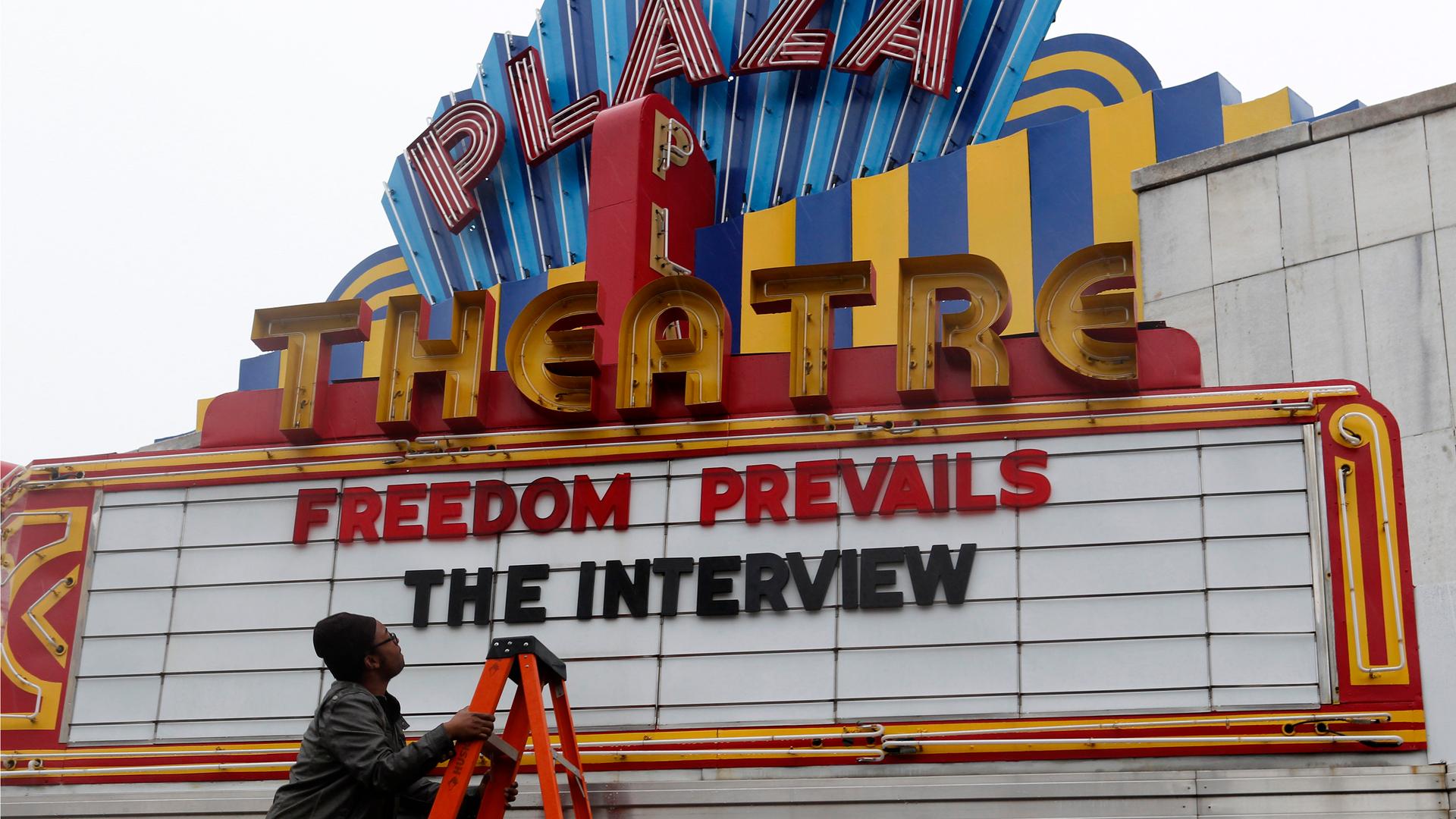 General Manager Brandon Delaney looks up at the marquee sign after the announcement that the Plaza Theatre would be showing the movie "The Interview" beginning Christmas Day in Atlanta, Georgia December 23, 2014.