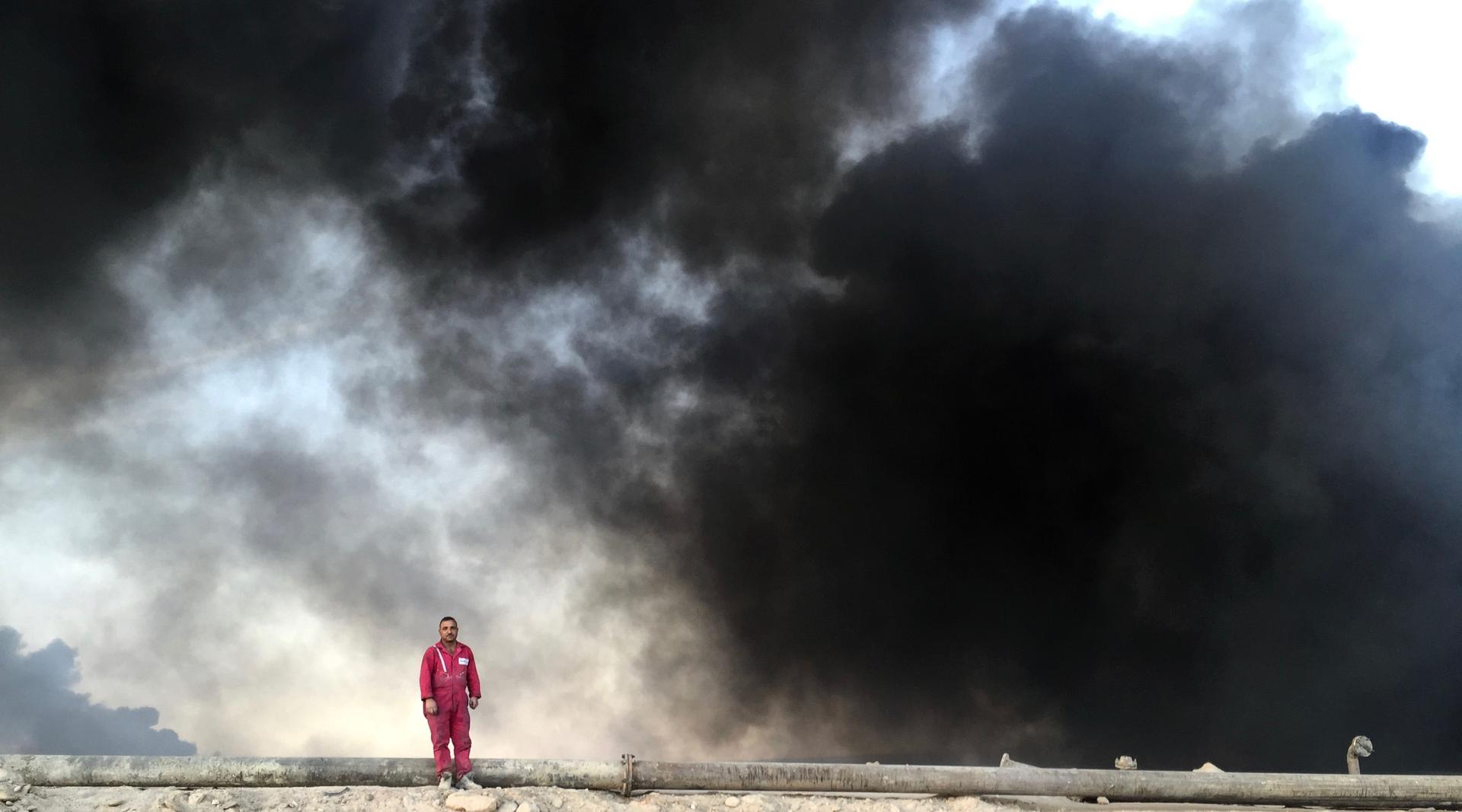 Iraqi firefighter at oil well fire in Qayyarah