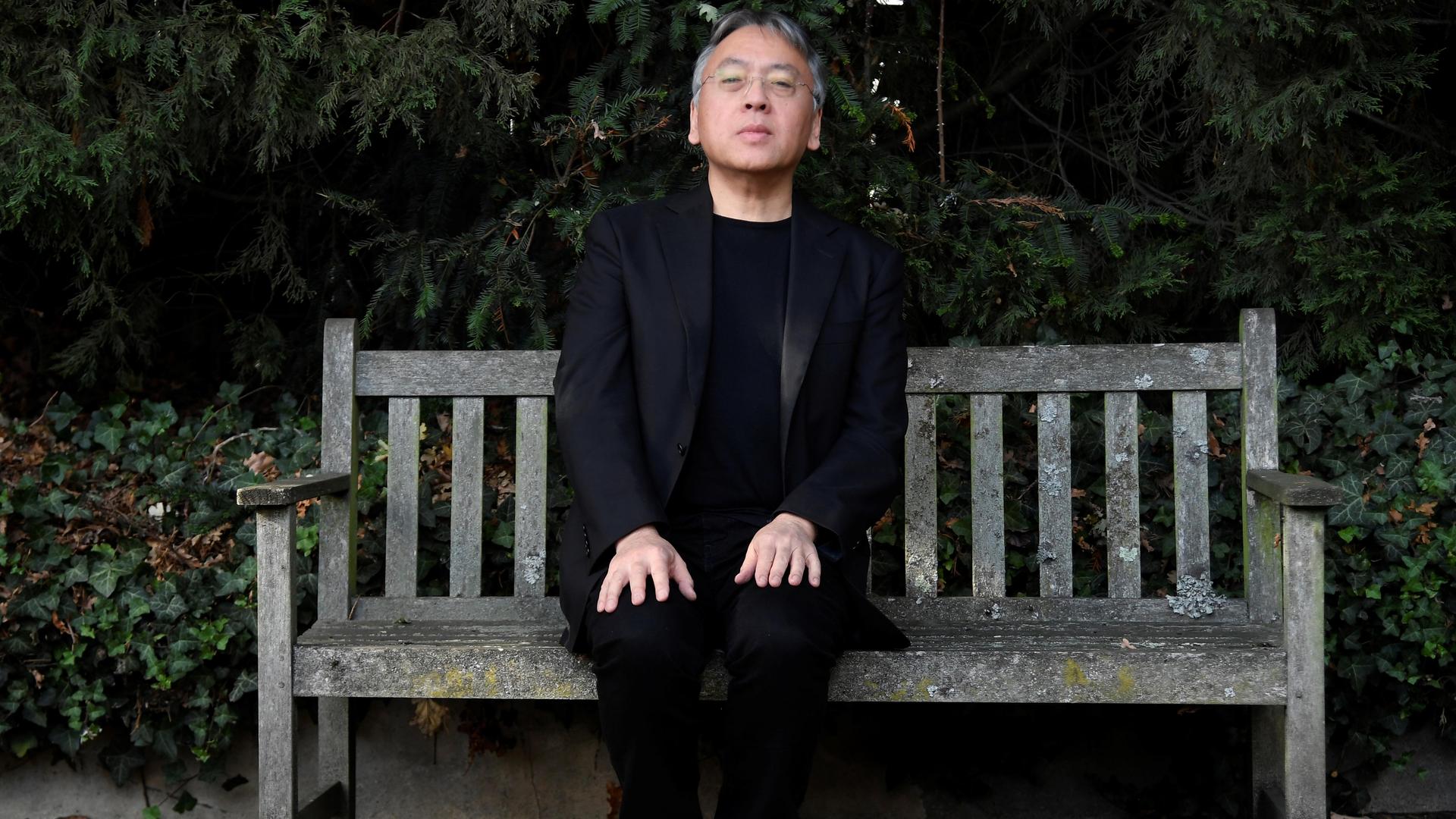 Author Kazuo Ishiguro poses for the media outside his home, following the announcement that he has won the Nobel Prize for Literature, in London, Britain, on Oct. 5, 2017.