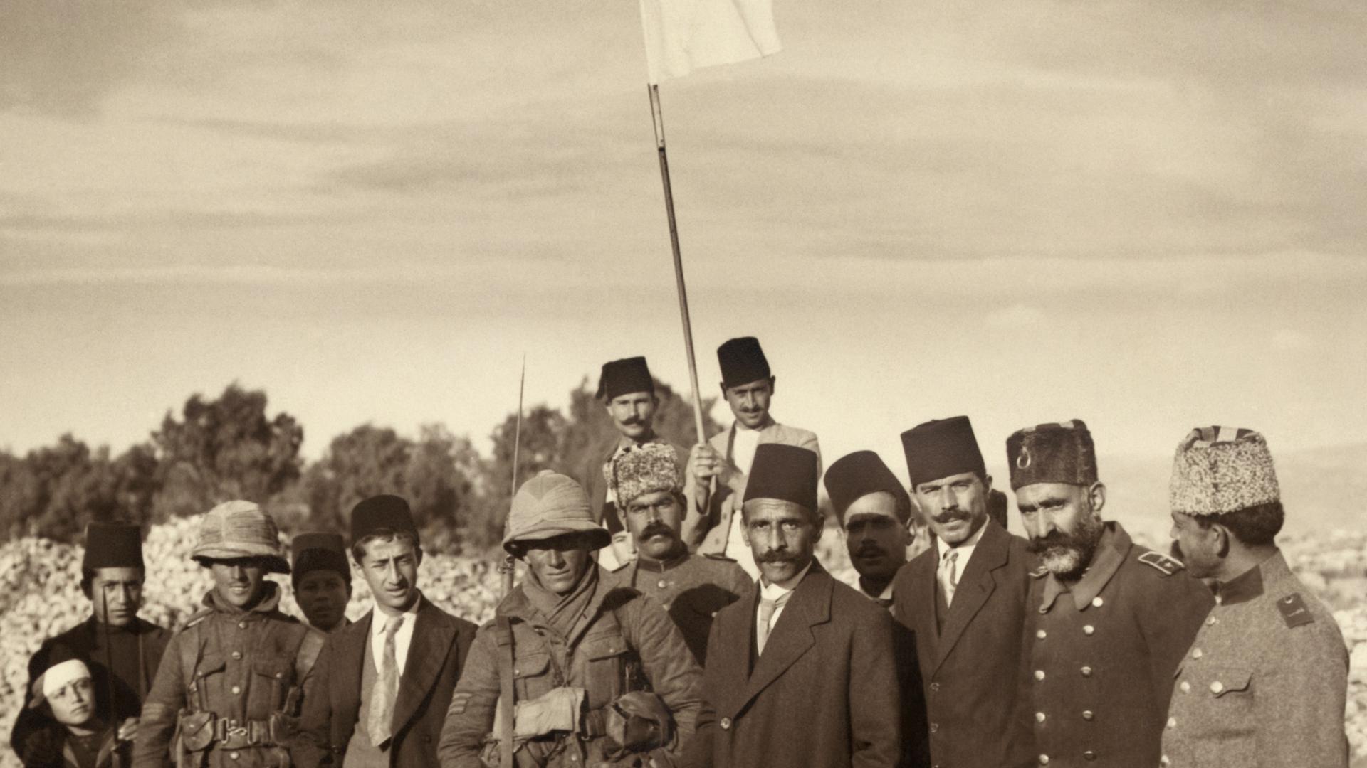 Mayor Husseini (center, wearing a fez), with two British infantry sergeants the morning of the surrender of Jerusalem, December 9th, 1917