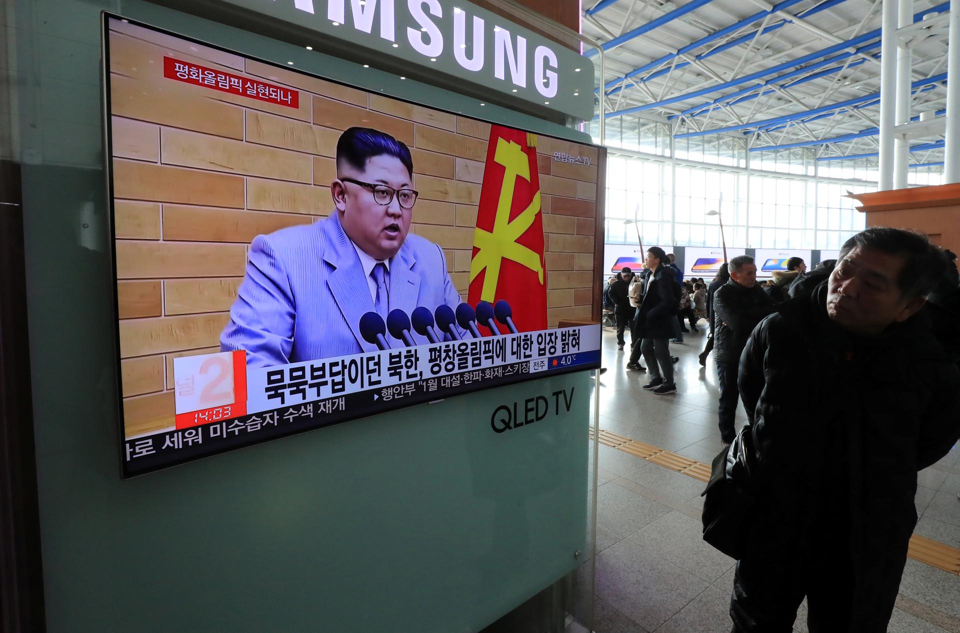 A man in Seoul, South Korea, watches a TV broadcasting a news report on North Korea's leader Kim Jong-un speaking during a New Year's Day speech.