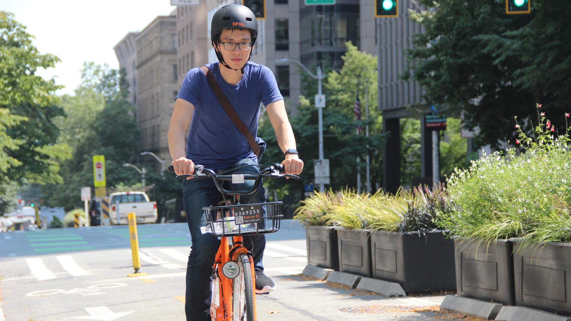 Derrick Ko, co-founder and CEO of Spin, rides one of his bikes in downtown Seattle. Spin currently has a permit to place 500 ride share bikes in Seattle.Derrick Ko, co-founder and CEO of Spin, rides one of his bikes in downtown Seattle. Spin currently has