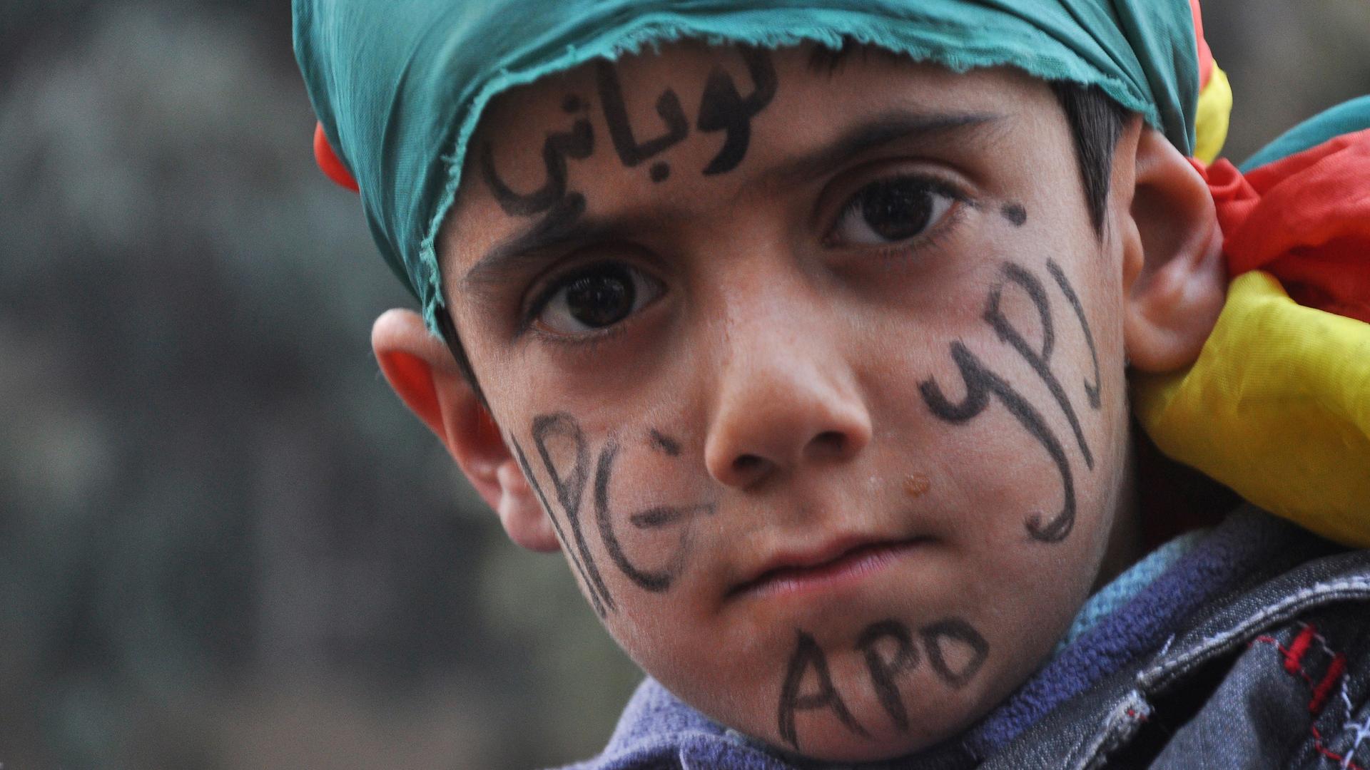 A Kurdish boy with "Kobane" written on his forehead takes part in a celebration in the Syrian Kurdish city of Qamishli, after it was reported that Kurdish forces took control of the Syrian town of Kobani, January 27, 2015.