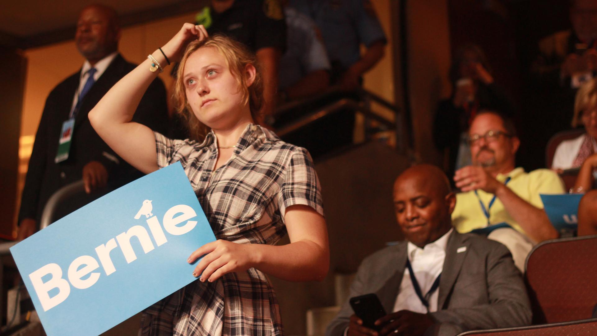 A woman holds a "Bernie!" sign at the Democratic National Convention