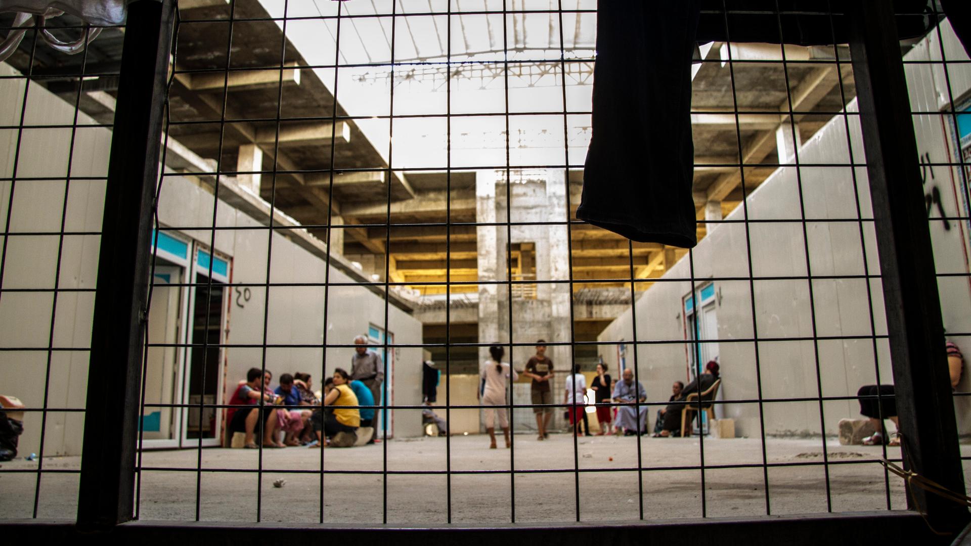 The main atrium of this would-be mall is now home to hundreds of Iraqis from villages outside Mosul. Here the concrete floors and walls give families more protection than the displaced families living in tents in a public park just across the street. 