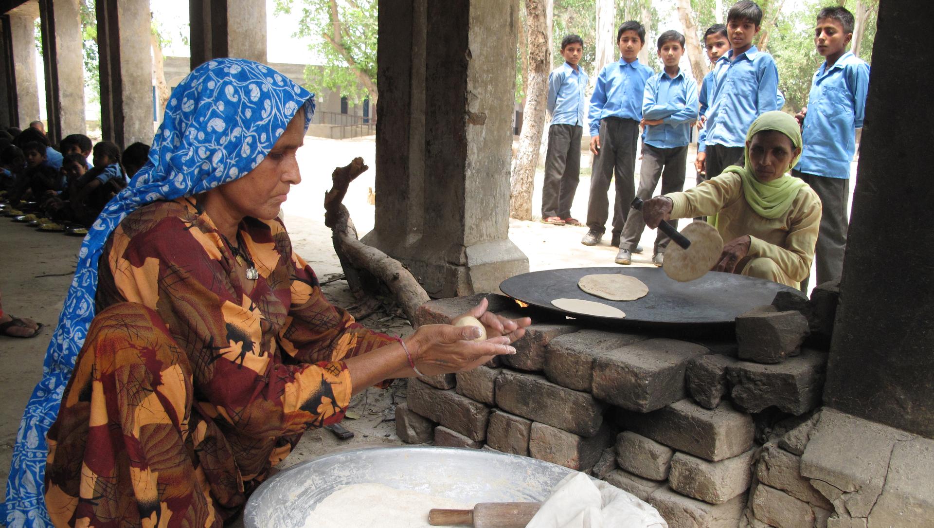 Cooks Beddo and Bimla, make rotis (a wheat flat bread) at a government school in a village  called Bawani Khera, in south central Haryana. The menu for the day is roti and a vegetable dish.