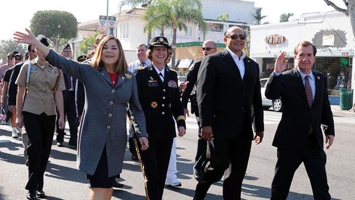 Maj. Gen. Megan P. Tatu, commanding general of the 79th Sustainment Support Command (center left), walks alongside Loretta Sanchez, Congresswoman, California 46th Congressional District, in the Fullerton Veteran’s Day Parade, Fullerton, Calif., Nov. 11.