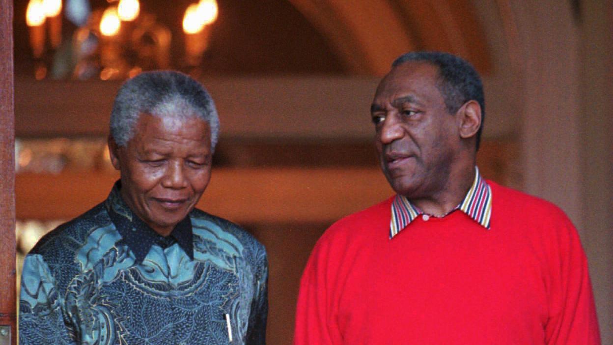 Bill Cosby and Nelson Mandela, then President of South Africa, appear before the press on March 20, 1997 in Cape Town. During his visit, Cosby gave a benefit performance on Robben Island for then visiting first lady Hillary Rodham Clinton, Mandela and Uni