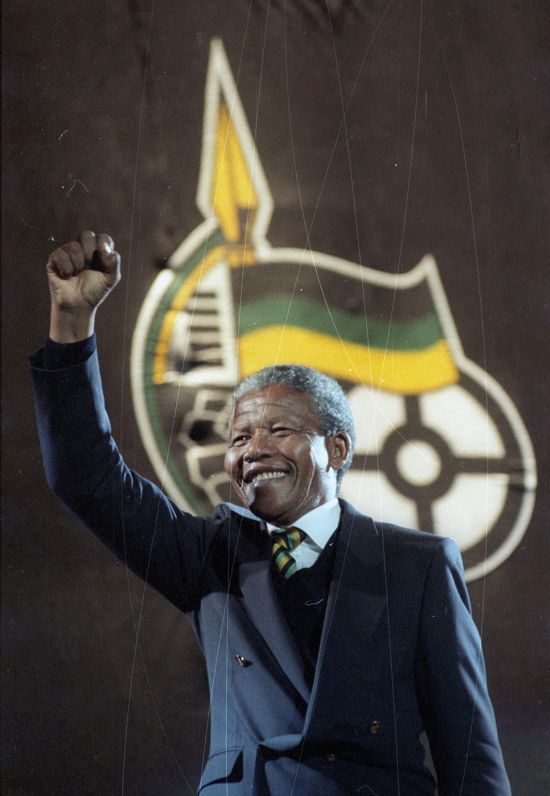 Nelson Mandela raises his fist as he walks on stage at Wembley Arena in London April 16, 1990. Mandela topped the bill at a rock concert in his honor. The sell-out concert was beamed live by satellite to about a dozen countries.
