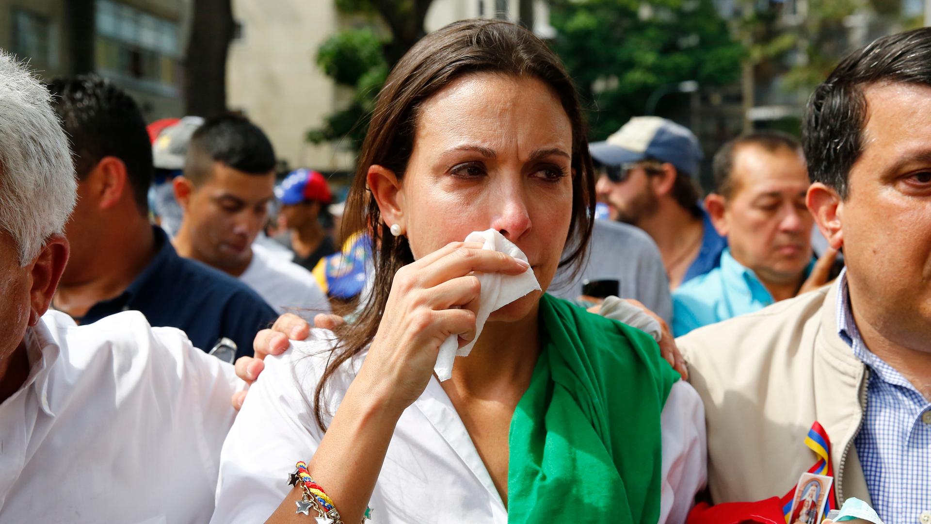 Venezuelan opposition leader Maria Corina Machado reacts after inhaling tear gas after she tried to take a seat at the national assembly in Caracas April 1, 2014.