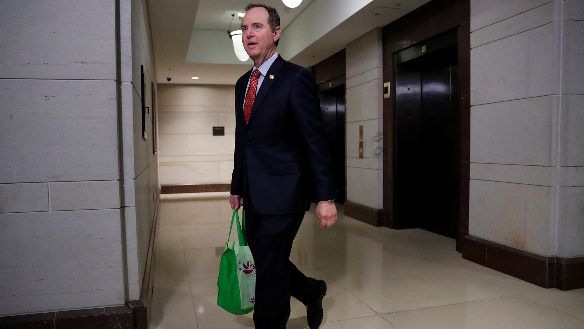Rep. Adam Schiff, carrying a green bag, arrives for closed meeting of the House Intelligence Committee in Washington.