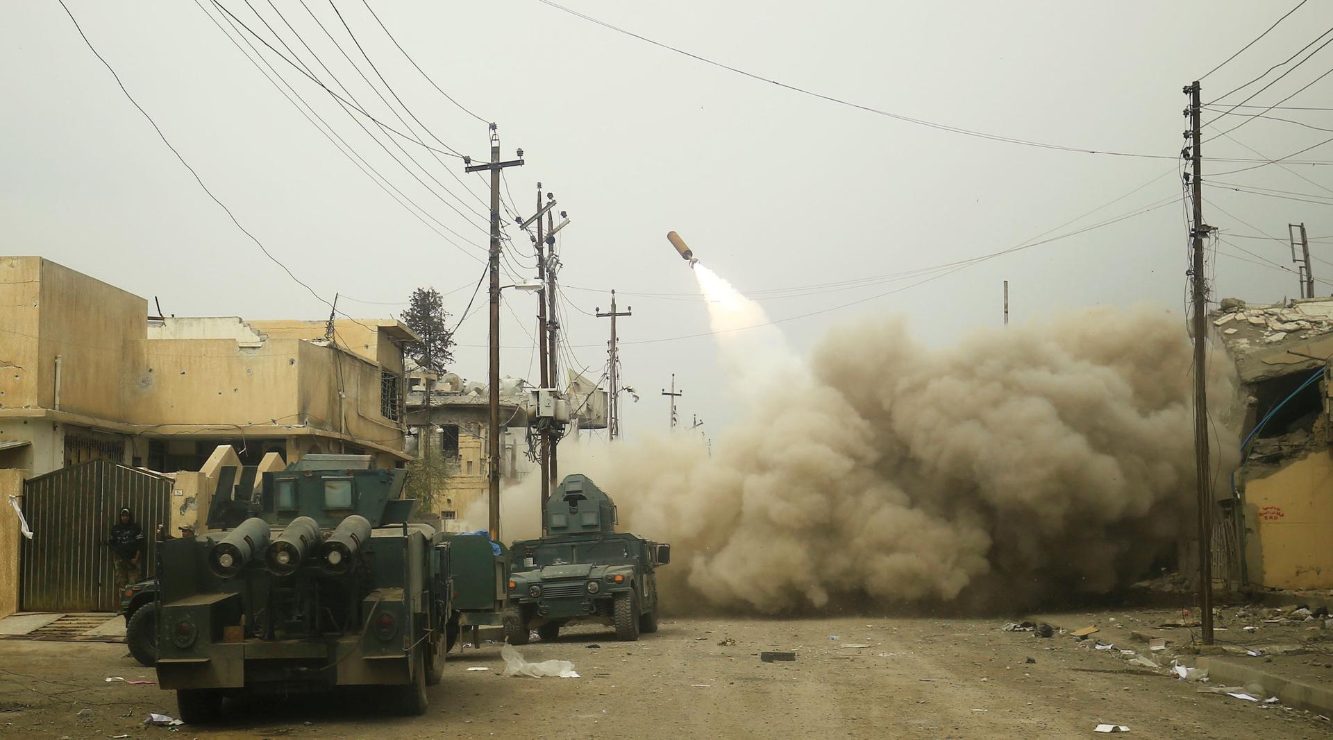 Iraqi rapid response members fire a missile against ISIS militants in Mosul, Iraq, on March 11.