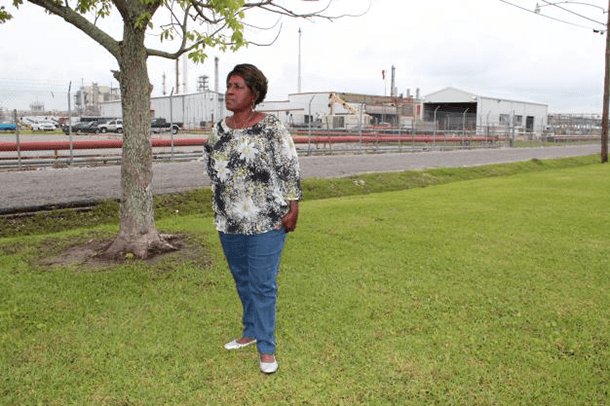 Margie Richard stands in what used to be her front yard, across the street from Shell's chemical plant in Norco, Louisiana. Richard pushed for the company to buy out the neighborhood and move residents.