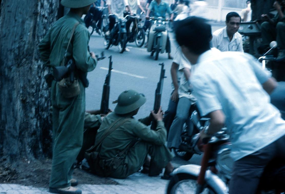 North Vietnamese troops and Saigon residents eye each other on the streets of the city on April 30th, 1975, the day the city fell to the government in Hanoi. 